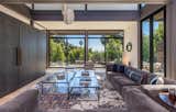 Living Room, Sofa, Accent Lighting, and Light Hardwood Floor Two stacked modules make up the double-height living room.   Photo 13 of 15 in Will Arnett Lists His Prefab-Hybrid Home in Beverly Hills for $11M