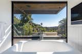 Bath Room and Freestanding Tub A large window framing landscape views elevate the bathing experience in the master bath.   Photo 7 of 15 in Will Arnett Lists His Prefab-Hybrid Home in Beverly Hills for $11M