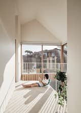 In this house in Melbourne, Australia, windows at the top and bottom of the double-volume living area flood both the first story and corridor upstairs with ample daylight. The double-height space makes the modest footprint of this part of the house feel open and light, says architect Sally Timmins.&nbsp;