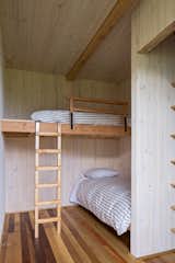 The smallest bedroom in the visitor wing has two bunkbeds, a closet, and a shared bathroom to the side.