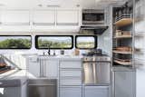 A view of the Living Vehicle kitchen with plenty of storage as well as the optional oven, dishwasher and insta-hot water system. 