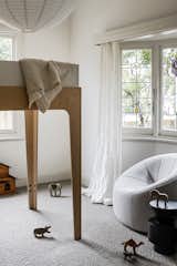 Inside one of the kids’ bedrooms at the front of the house is an Oeuf Perch lofted double bed, a Pumpkin armchair by Ligne Roset, and a Grain Cut side table in black from Domo.