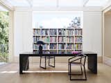 The library, also located in the quiet zone, features a custom table by Madeleine Blanchfield Architects, Henry Time SB 1901 chairs, and an Atollo lamp by Vico Magistretti for Oluce.