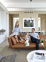 Madeleine Blanchfield sits with her husband Guy, son Aston, and daughter Estelle in their open-plan living room on the top floor of their home. 
