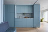 A small galley kitchen is built into the larger of the two prefabricated pod volumes.