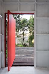 The bright red door—a favorite feature of the design duo—was built on-site from plywood.