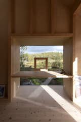 This strategically placed window with an operable opening frames views of the landscape. 
