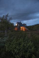 A multigenerational Oslo family tapped Gartnerfuglen Arkitekter to design an extension to their traditional 1980s log cabin near Hardangervidda National Park in Norway. The facade is clad in highly durable, untreated ore pine that will develop a silvery patina over time, helping the building blend into the landscape.&nbsp;