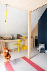 A Rafa Kids swing hangs below the loft bed. The large desk was designed for playing with Legos. 