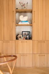 Custom oak cabinetry by Woodchuck is fitted with Futugami handles via Pantoufle. 