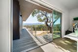 Deep roof eaves shield the home from unwanted solar gain. A raised concrete floor absorbs solar radiation for passive heating in winter.