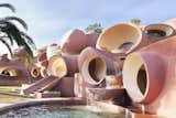 Exterior, Concrete Siding Material, House Building Type, and Curved RoofLine Lovag's celebration of circulation and motion is also represented in this three-tiered waterfall feature.  Photo 8 of 21 in Pierre Cardin’s Retro-Futuristic Bubble Palace in Cannes Is On the Market