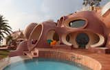 Exterior, Curved RoofLine, House Building Type, and Concrete Siding Material Red Carrera marble floors used throughout match the domes’ dusty pink hue.  Photo 15 of 21 in Pierre Cardin’s Retro-Futuristic Bubble Palace in Cannes Is On the Market