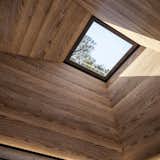 A square skylight is positioned directly above the bed for stargazing. 