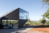In the Chilean eco-community of Fundo Puertecillo, 2DM Architects designed a gemstone-shaped dwelling that cantilevers out toward the Pacific Ocean. The asymmetrical shape gives the cabin a dynamic look from the exterior, and the layout maximizes ocean views.