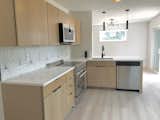 Kitchen, Engineered Quartz Counter, and Range Kitchen  Photo 2 of 11 in Nordic Retreat by La Bar Properties, Inc