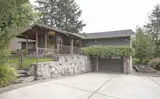 Basalt stone wall and slab steps lead  to a stepping stone path.