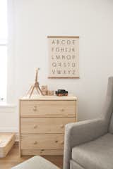 Kids Room, Bedroom Room Type, Dresser, Chair, Toddler Age, Neutral Gender, and Medium Hardwood Floor  Photos from Simple and Beautiful Chicago Family Apartment