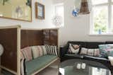 Living Room, Sofa, Bench, and Pendant Lighting A high-framed bench with colorful striped cushions brings even more interest to the living room.  Photo 16 of 19 in Colorful & Eclectic Danish Home by Petra Ford