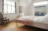 Bedroom, Bed, Chair, and Medium Hardwood Floor The master bedroom is both contemporary and classic at the same time.  Photo 18 of 19 in Colorful & Eclectic Danish Home by Petra Ford