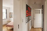 A black and neon orange For Sale sign hangs in the hallway outside the master bedroom, adding a bit of whimsy to the space.