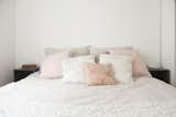 Bedroom and Bed pink and white pillows atop an earth-toned bed  Photo 1 of 13 in Pretty and Sweet Family Flat by Petra Ford
