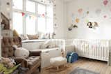 children's nursery filled with plush toys, hot air balloon decor, and light strings