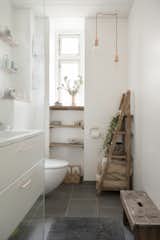 Bath Room, Drop In Sink, Pendant Lighting, and One Piece Toilet earth toned, neutral bathroom with wooden rack, bench, and shelving  Photo 8 of 13 in Pretty and Sweet Family Flat by Petra Ford