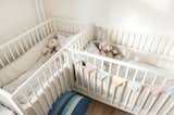 cream cribs in child's nursery 