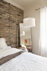 A mirror  in the corner makes the room feel a little larger