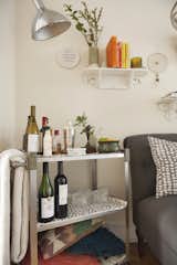 A vintage bar cart stocked with booze is a fun feature in the alcove