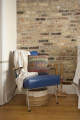 A blue leather chair sits stylishly in the corner