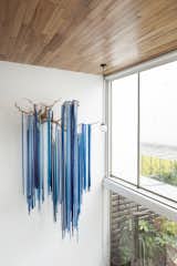 Windows, Sliding Window Type, and Metal The bright blue hanging wall art is an immediate focal point, drawing the eye up the high ceilinged wall   Photo 13 of 23 in Art and Plant Filled Mexico City Abode by Petra Ford
