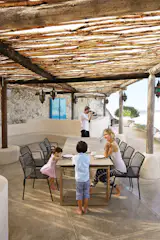 Italian 'high pressure laminate' top and stunning upcycled, reclaimed teak legs; with three possible positions.Complimented by  MANDA outdoor wicker chairs.