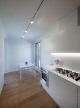 Kitchen, Medium Hardwood Floor, Quartzite Counter, White Cabinet, and Track Lighting Kitchen  Photos from CM House