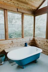 Salvaged 1910s clawfoot tub in screened porch