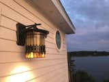 Clapboard exterior with circular window and Quoizel light.