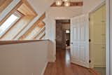 New flooring and half wall secures the upstairs hallway. 