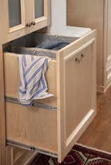 Hidden features were included through out this design to ease the family's daily routine. For example,  a pull-out hamper was installed, that way there is no tripping over a basket of clothes come laundry day.