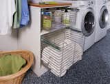 The sliding chrome baskets and matching hardware reflect the metallic look of the washer/dryer and tie the design together. Drying racks allow you to hang and drip-dry your clothes without causing a mess or taking up space. 