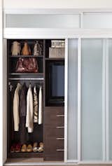 The four sliding doors open to either side to view the TV or to the center to access clothes.
