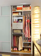 Sliding chrome baskets provide a modern way to easily access important belongings, and larger shelves at the top of the closet offer room to store luggage or other sparingly-used items. Slanted shoe shelves make it easy to match your most fashionable footwear to any outfit.