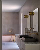 A restrained material palette in the primary bathroom enhances a sense of repose.