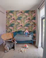 Floral wallpaper adds a whimsical note of color in the nursery.
