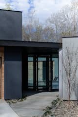 Exterior, Stucco Siding Material, Flat RoofLine, Wood Siding Material, and House Building Type Entry Door with View to Courtyard and Lake  Photo 15 of 19 in Gerendák by Wittehaus