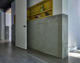 Exposed Concrete Wall and Built-In Shelving