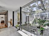 The enclosed glass breezeway overlooks a private courtyard and connects the original home with the new modern addition