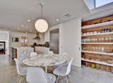 The designer kitchen has it all:  Carrara marble bar, Miele and Wolf appliances, custom Euro-style cabinets, and a pantry area with a barn door style sliding door
