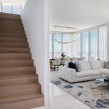 A staircase in the Jade Signature Sky Villa leads to living areas and bedrooms on the second level.