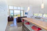 Kitchen, Wood Counter, Concrete Floor, and White Cabinet Interior shot of the Quarterdeck Beach Lofts  Photo 2 of 6 in Quarterdeck Beach Lofts by Nicholas Fudge Architects